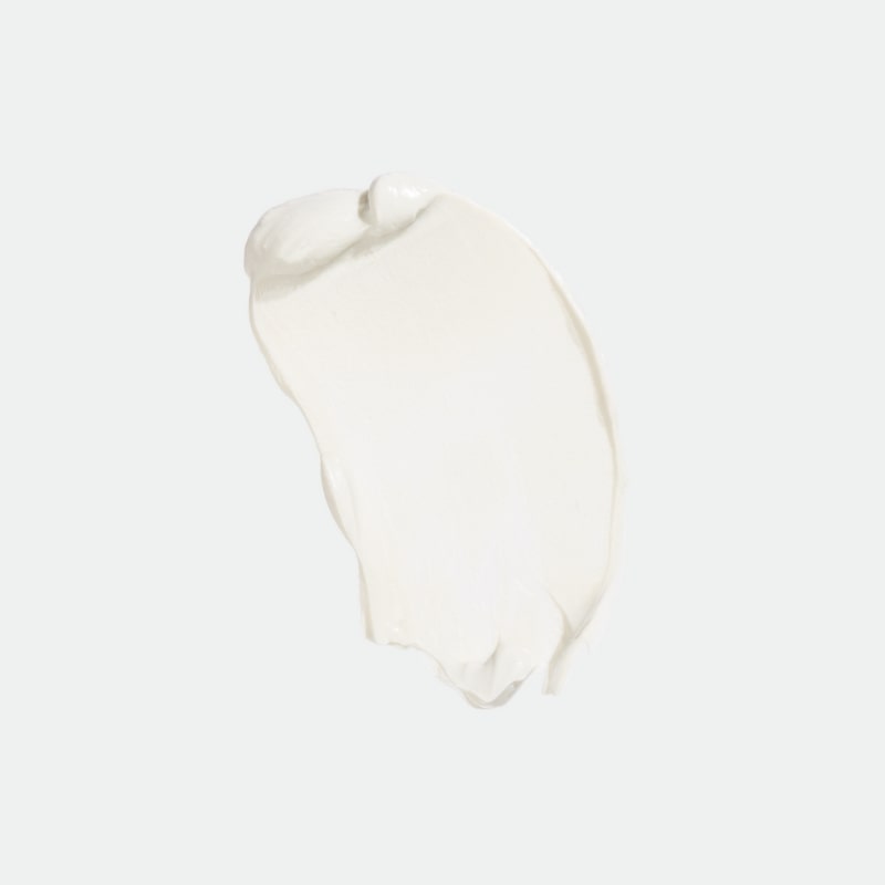 White sunscreen cream smear on pale background