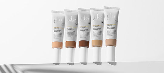 Five glo skin-tint tubes in a row showing shade range from light to dark