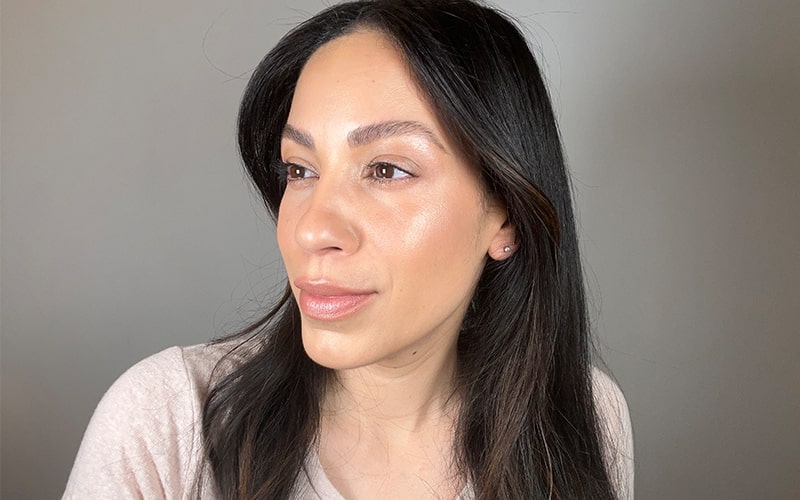 Woman with subtle cheekbone and nose highlight, head turned slightly left