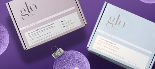Two glo skin product boxes on purple background with glitter ornaments