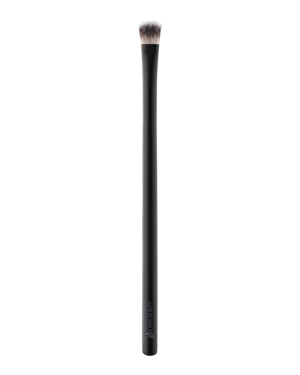 Flat-topped dense eye base brush with black handle marked glo SKIN BEAUTY