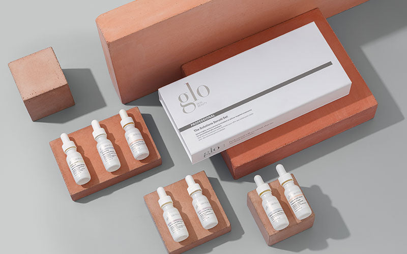 glo PROFESSIONAL The Solutions Serum Set box with six dropper-serum bottles arranged on terracotta blocks