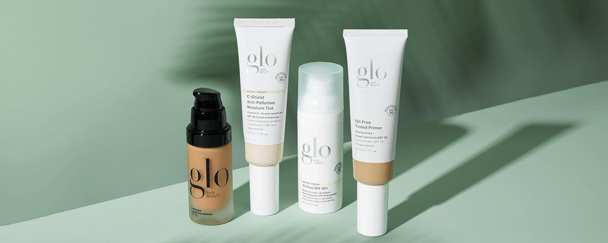 View of four face products: C‑Shield Moisture Tint, Tinted Primer SPF 30, Oil‑Free SPF 40+ and foundation on green background