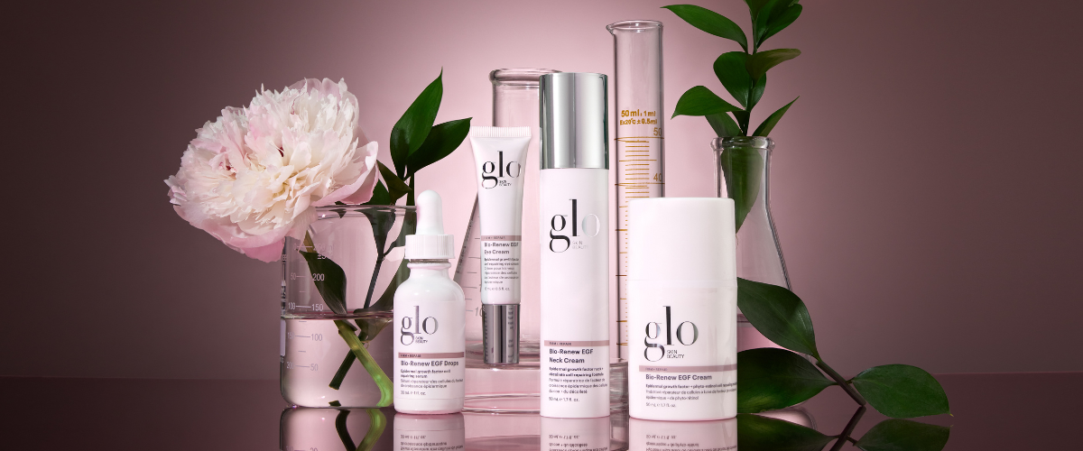 glo skin beauty products labeled Bio-Renew EGF Drops, Bio-Renew EGF Neck Cream, Bio-Renew EGF Cream with flowers