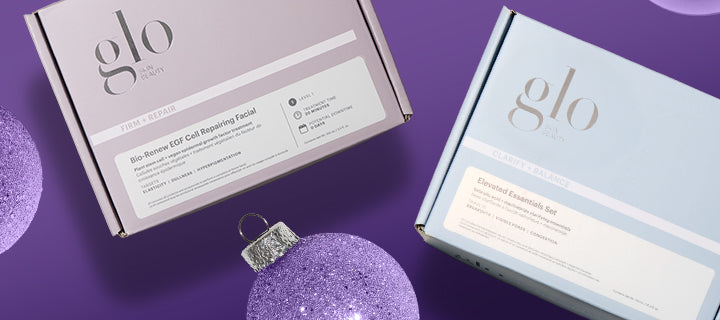 Two glo skincare boxes and purple glitter ornament; labels read 'Bio-Renew EGF Cell Repairing Facial' and 'Elevated Essentials Set'.