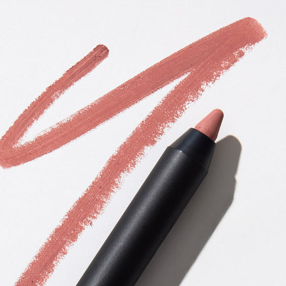 Dusty rose lip pencil with sharpened tip and two matte swatch strokes on white background