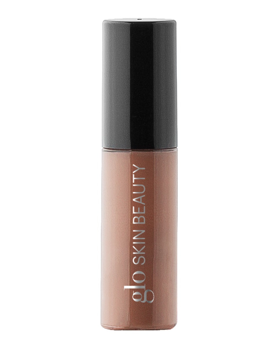 Front view of Conditioning Lip Gloss sample in Skinny Dip showing nude brown shade and black cap on white background