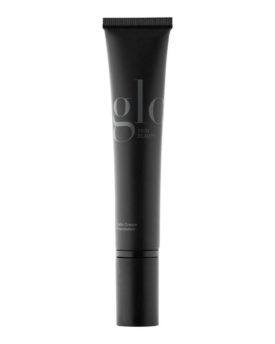 glo SKIN BEAUTY tube labeled Satin Cream Foundation in matte black packaging